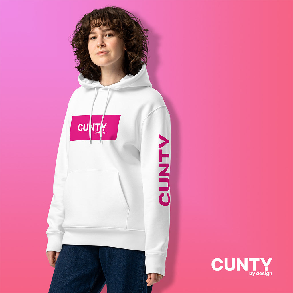 Woman Wearing White Cunty Classic Premium eco hoodie with Fuchsia Cunty By design Logo branding on the front, left arm and inside label – Bold, Sustainable, & Unapologetic Comfort | Unisex Streetwear | Designer | Free Shipping | LGBTQ+ |