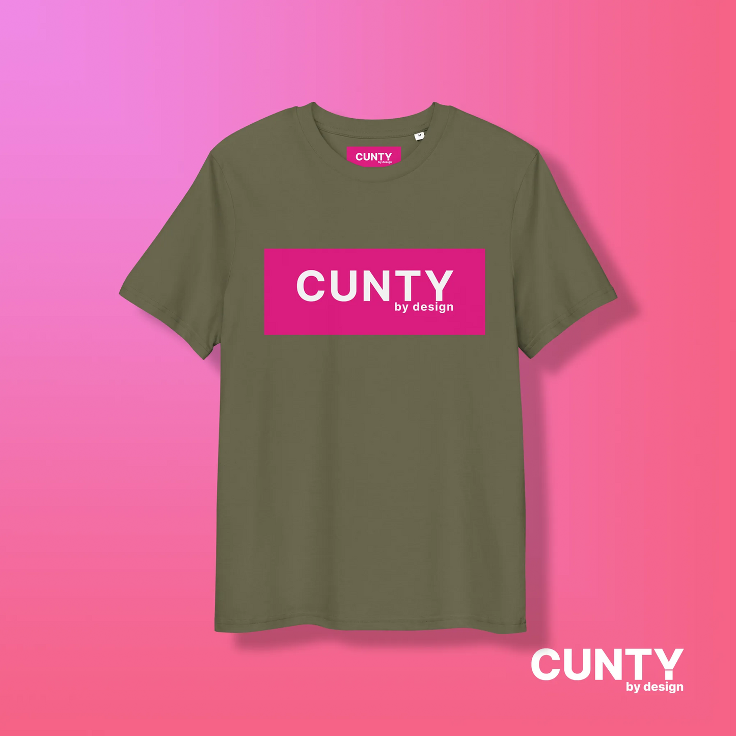 Khaki with Fuchsia Design: A khaki green unisex t-shirt displaying the "Cunty by Design" logo in a bold fuchsia rectangle, presented on a pink gradient background.
