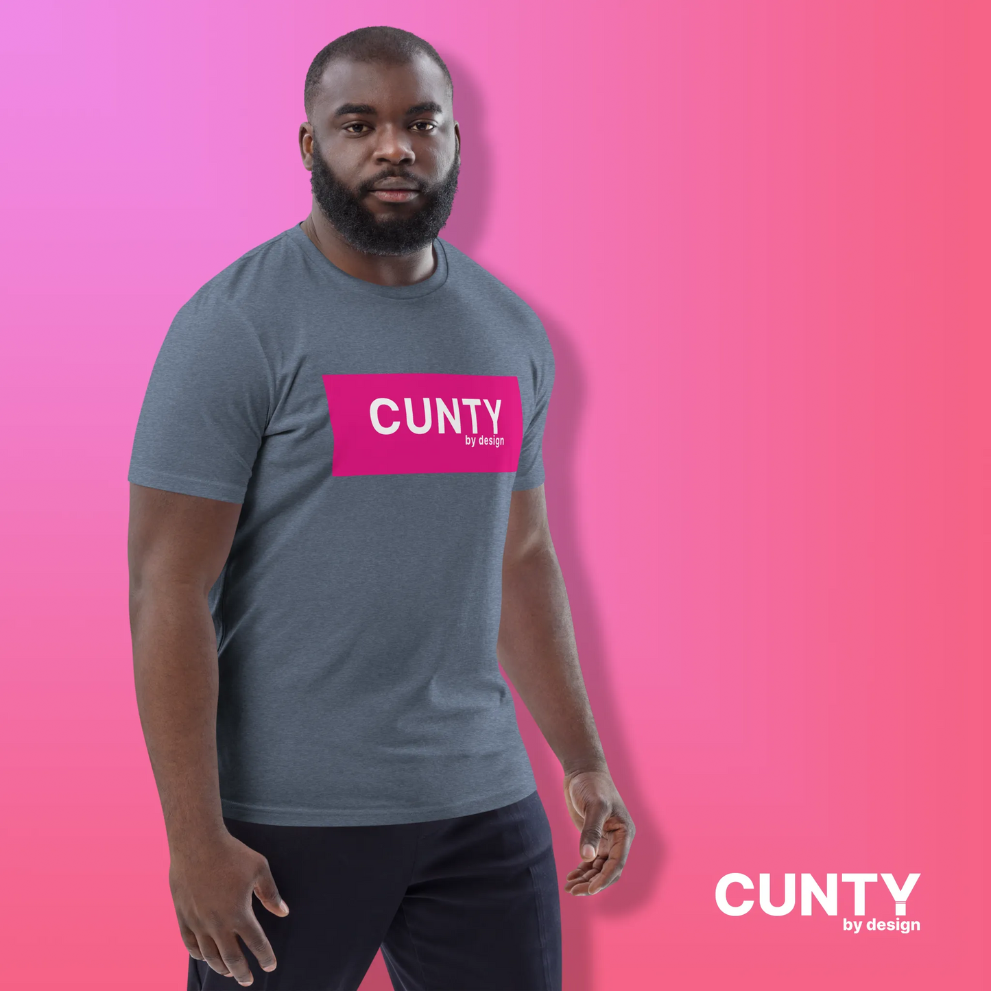 Man in Heather Blue with Fuchsia Design: A man wearing a heather blue unisex t-shirt with the "Cunty by Design" logo in a fuchsia rectangle, styled against a pink gradient background.