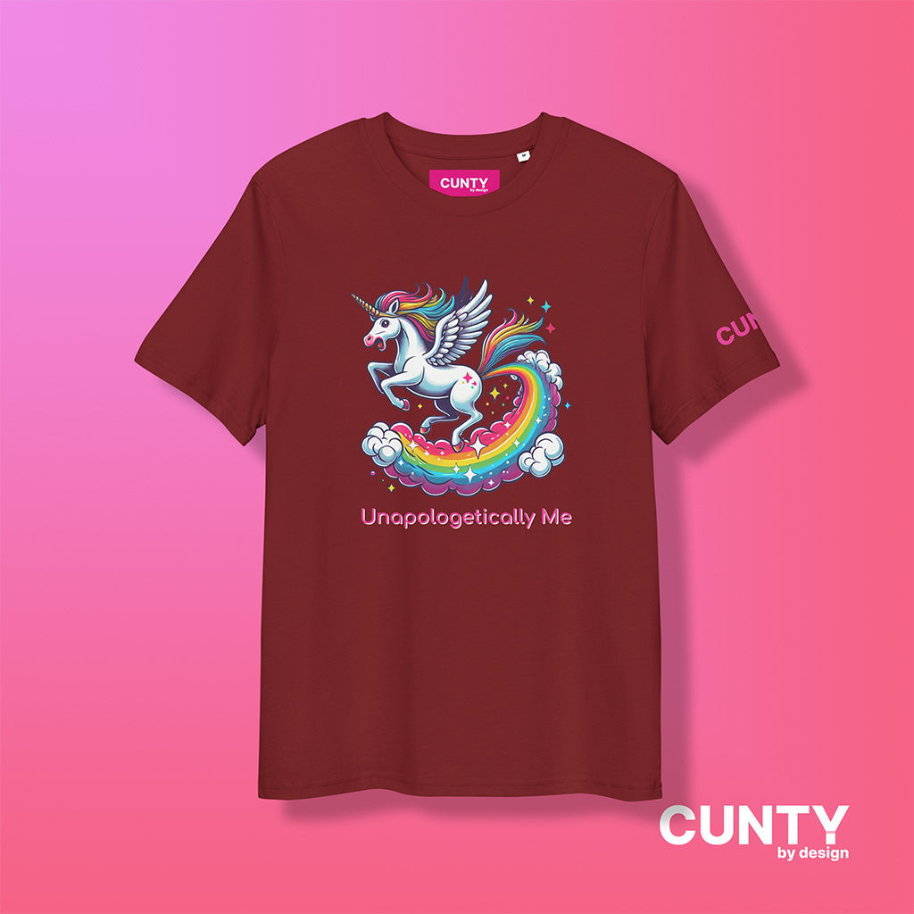 a burgandy colored graphic t-shirt with Unapologetically Me written on it and an image of a Unicorn galloping on a rainbow – Organic, Bold, and Fierce, by cunty by design.