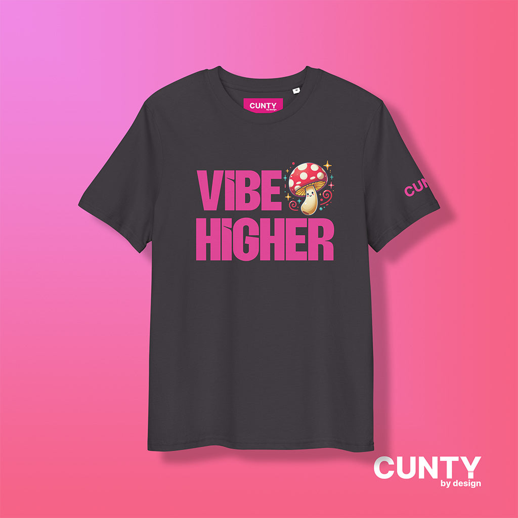 anthracite organic cotton t-shirt featuring the bold text "Vibe Higher" in vibrant pink, paired with a colorful magic mushroom graphic. The shirt has a unisex design with a Cunty by Design logo on the sleeve, and inside neck label displayed against a fuchsia background.