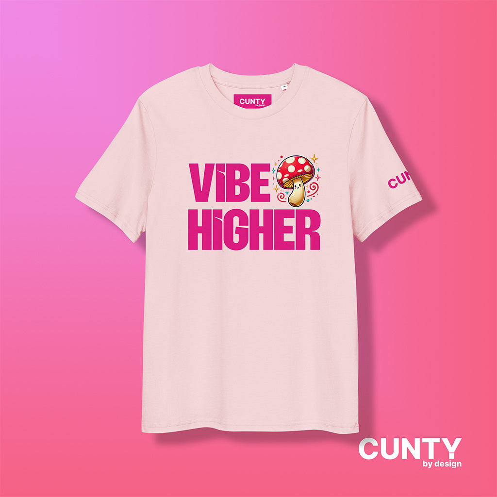 cotton pink organic cotton t-shirt featuring the bold text "Vibe Higher" in vibrant pink, paired with a colorful magic mushroom graphic. The shirt has a unisex design with a Cunty by Design logo on the sleeve, and inside neck label displayed against a fuchsia background.