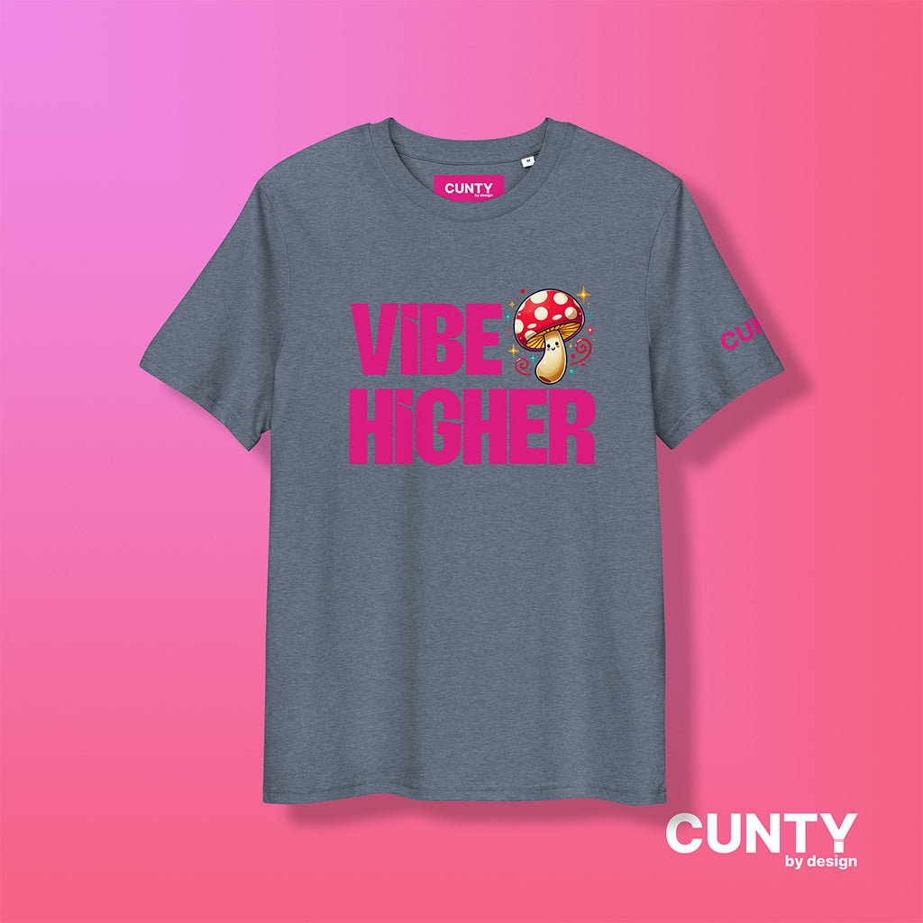 dark-heather-blue organic cotton t-shirt featuring the bold text "Vibe Higher" in vibrant pink, paired with a colorful magic mushroom graphic. The shirt has a unisex design with a Cunty by Design logo on the sleeve, and inside neck label displayed against a fuchsia background.