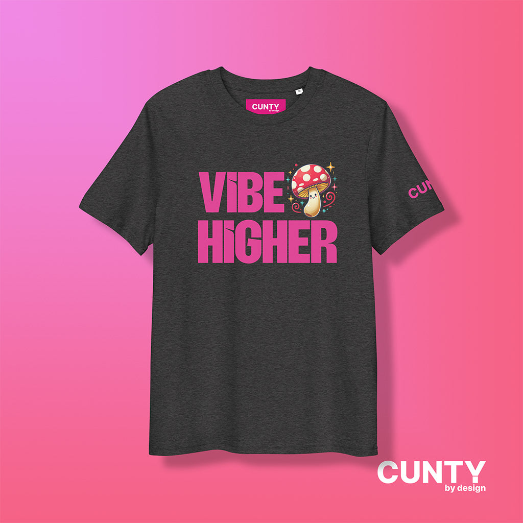 dark-heather-grey organic cotton t-shirt featuring the bold text "Vibe Higher" in vibrant pink, paired with a colorful magic mushroom graphic. The shirt has a unisex design with a Cunty by Design logo on the sleeve, and inside neck label displayed against a fuchsia background.