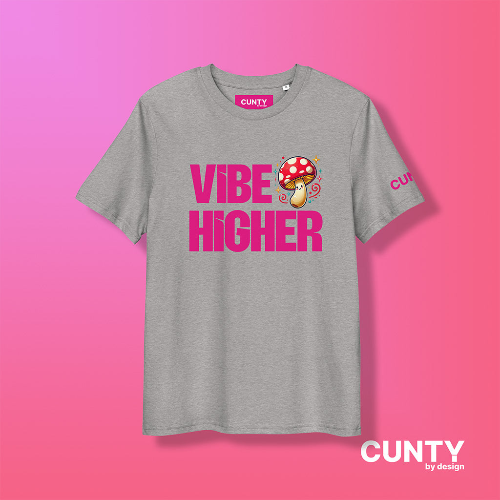 heather-grey organic cotton t-shirt featuring the bold text "Vibe Higher" in vibrant pink, paired with a colorful magic mushroom graphic. The shirt has a unisex design with a Cunty by Design logo on the sleeve, and inside neck label displayed against a fuchsia background.