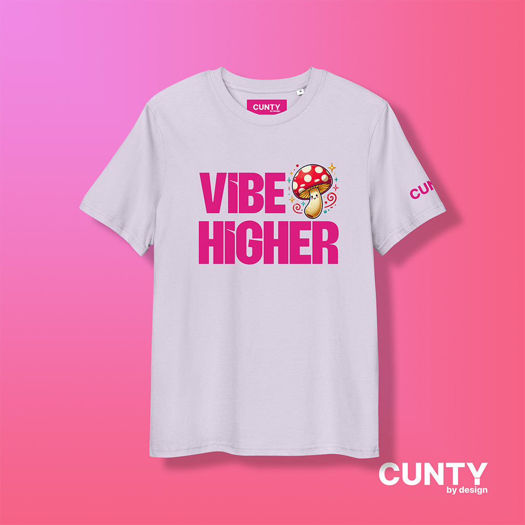 lavender organic cotton t-shirt featuring the bold text "Vibe Higher" in vibrant pink, paired with a colorful magic mushroom graphic. The shirt has a unisex design with a Cunty by Design logo on the sleeve, and inside neck label displayed against a fuchsia background.
