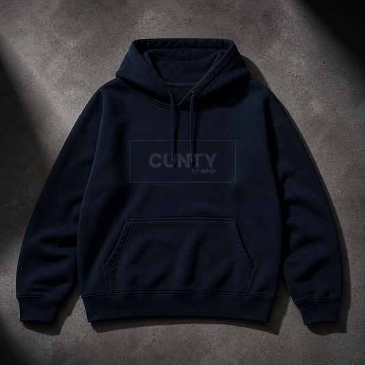 French Navy Blue hoodie with 'CUNTY' logo text on a gray concrete surface